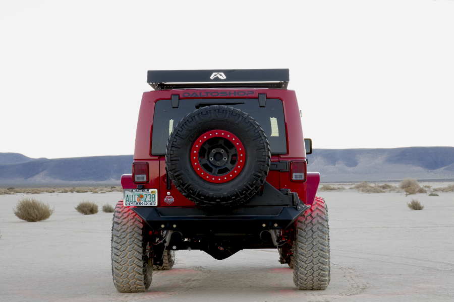 The custom Rubicon drives away from the camera, giving a view of the rear bumper.