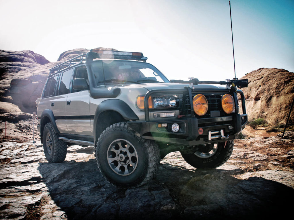 Toyota FJ80 on top of a rock