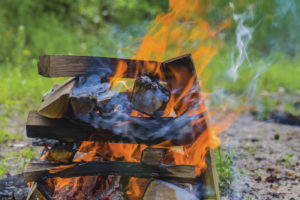 The crisscross layers of kindling are what makes the log cabin fire burn steadily and hot. The layers keep fuel right over the fire which helps it continue burning without having to tend it too often.