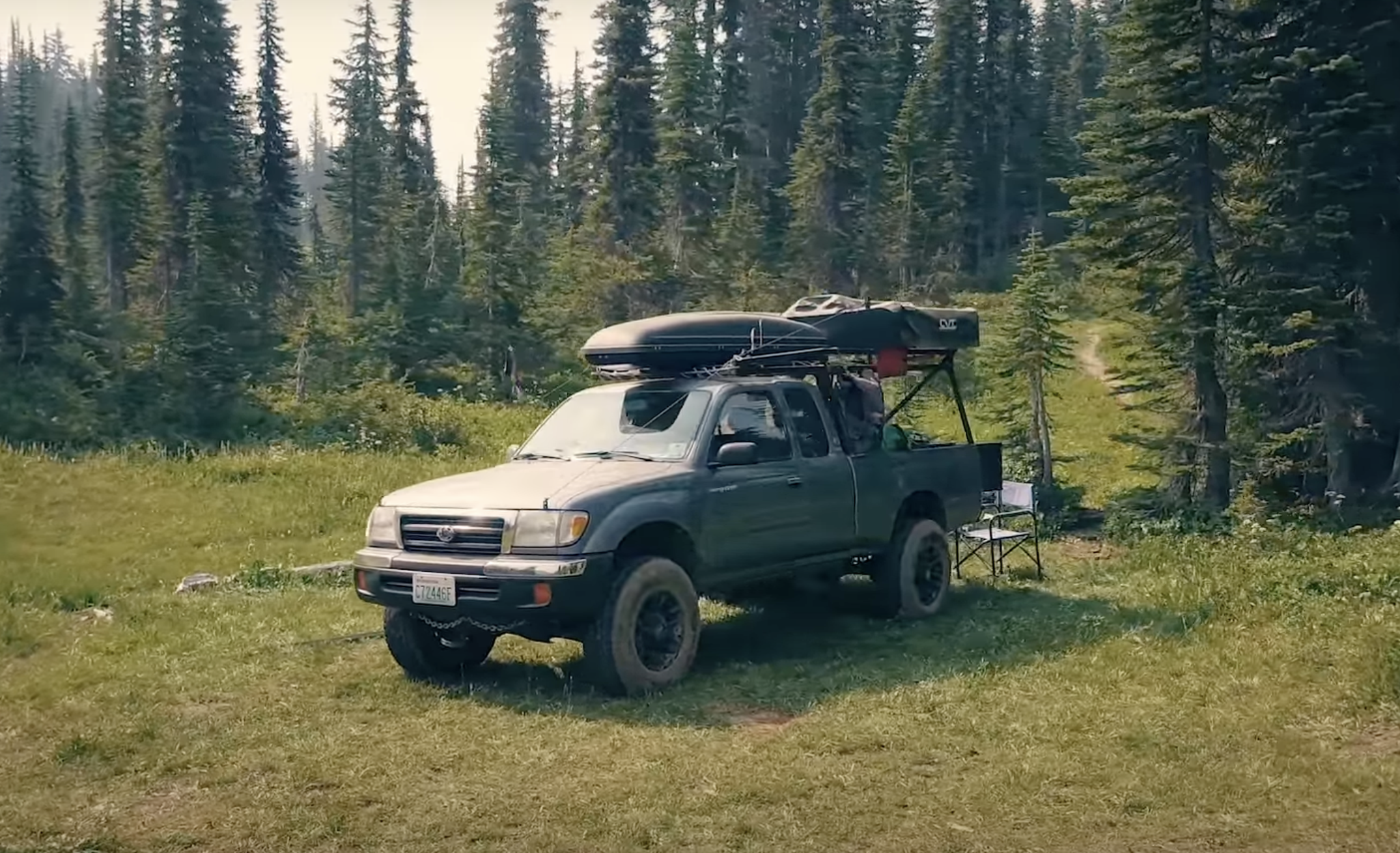 The budget built Tacoma parked in a grass field.