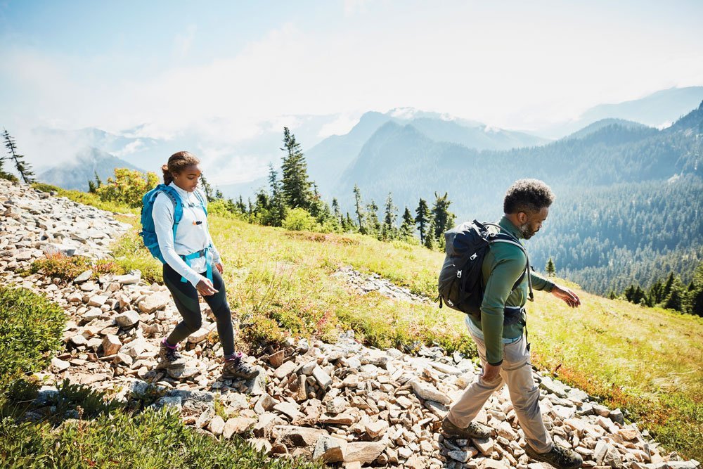 Man and woman walking downhill