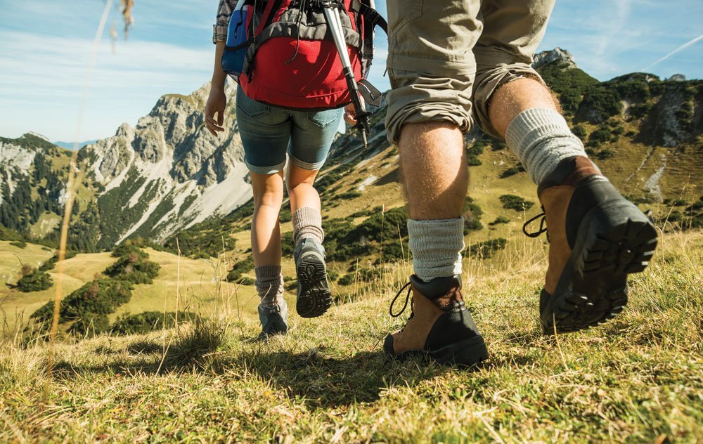 Two people walking downhill