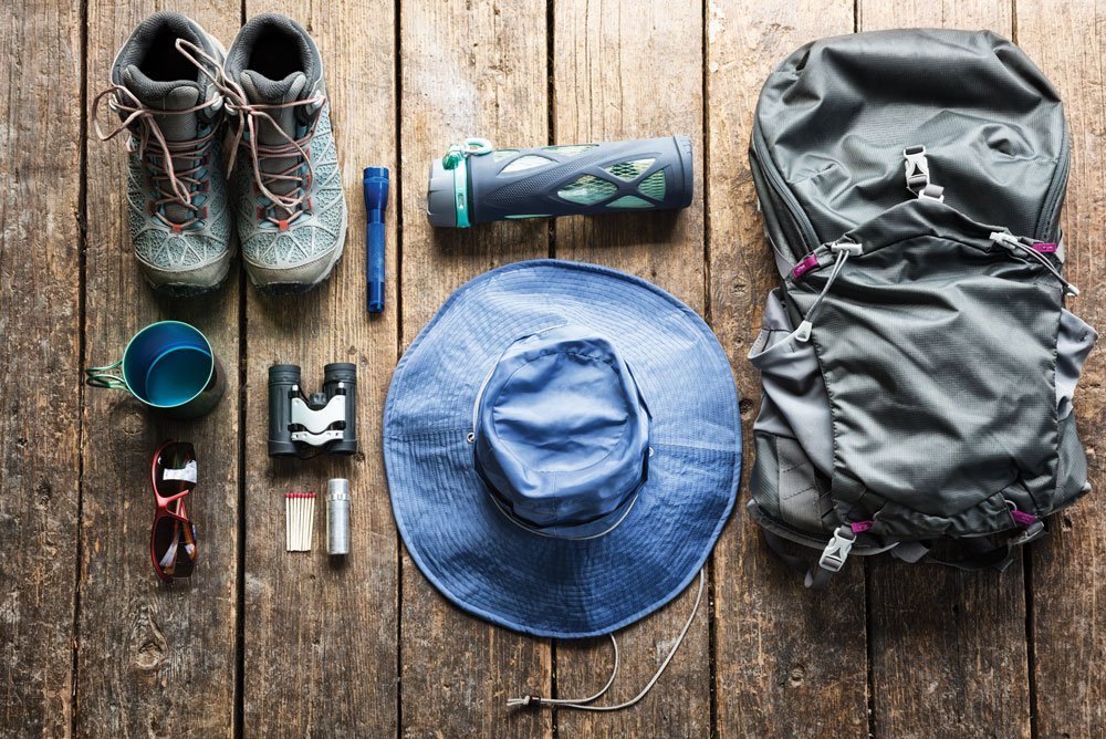 Shoes, cup, flashlight, binoculars, sunglasses, matches, hat, go-bag