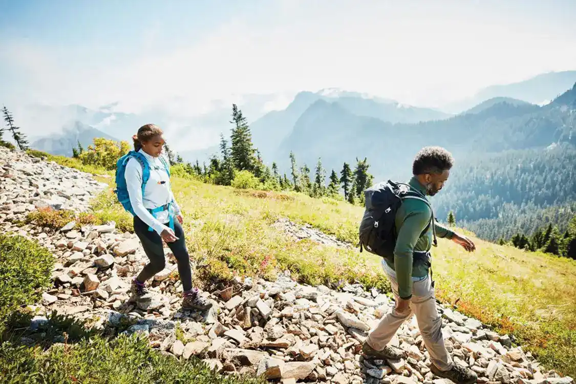 Man and woman walking downhill