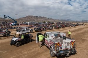 The trucks are lined up at the start and safety gets set at 2020 Mint 400.