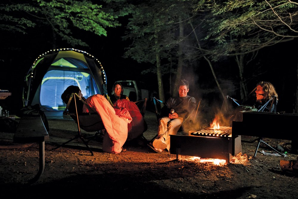 cold weather gear using technical blanket by campfire