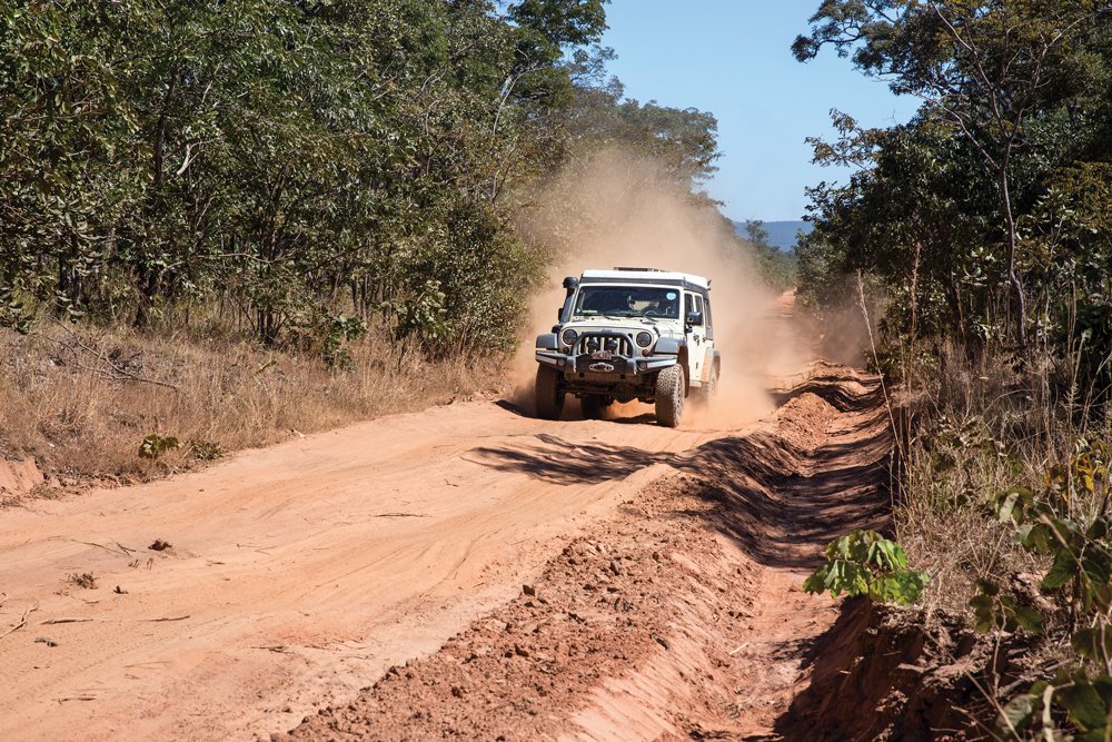 Jeep traveling down dirt road in Zambia