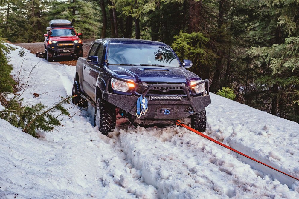 Toyota being pulled out of snow using a recovery rope