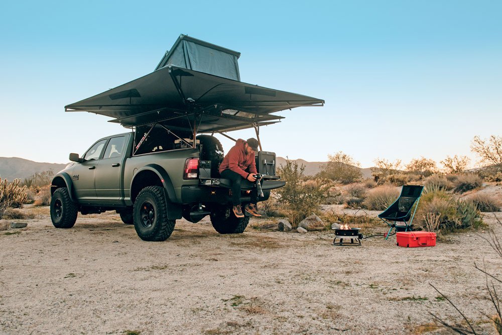 Owner and photographer by trade sitting on the tailgate of his truck