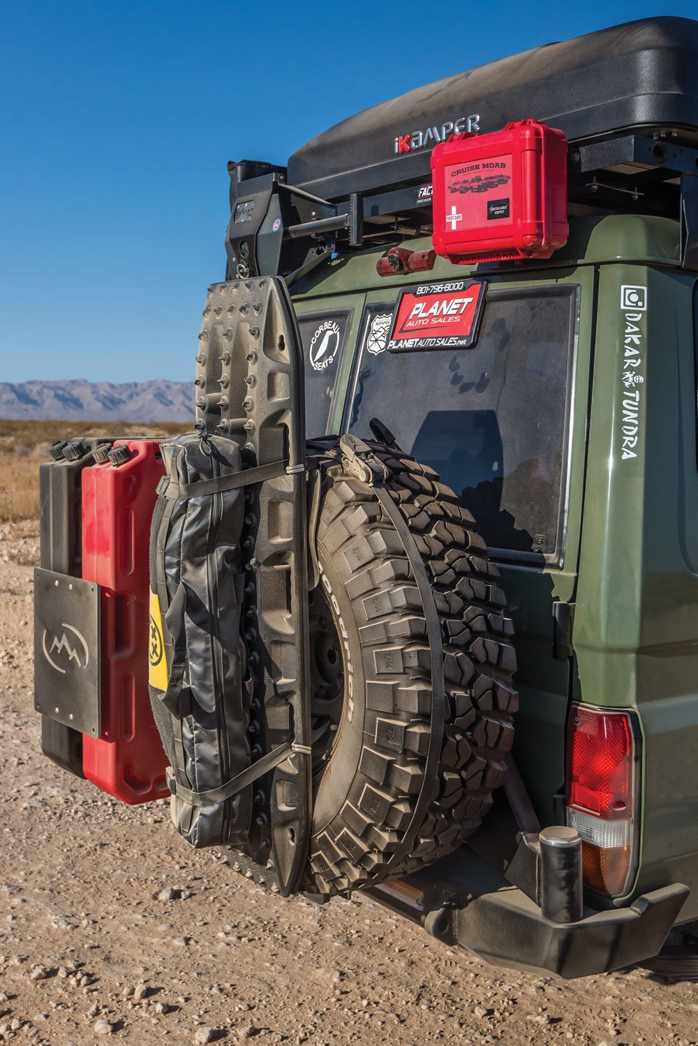 Rearview of Troopy with recovery and safety equipment and spare fuel