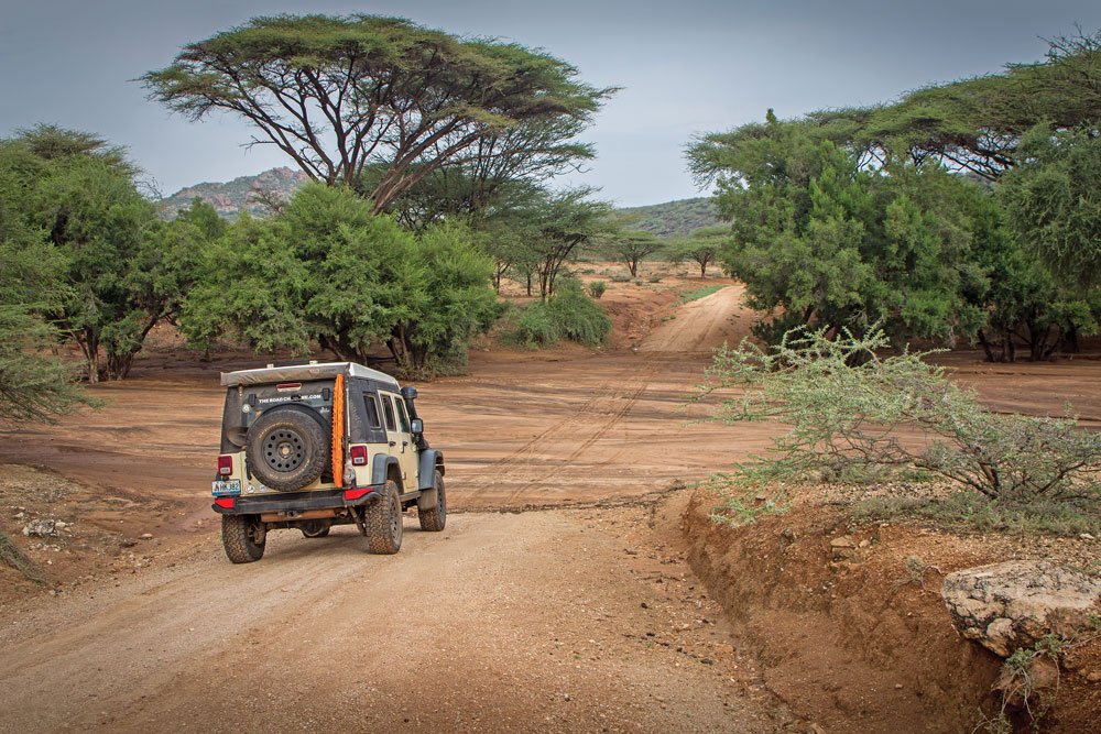 Jeep traveling through dry riverbed