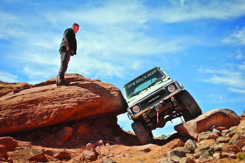 Women enjoying rock climbing in her Suzuki Samurai