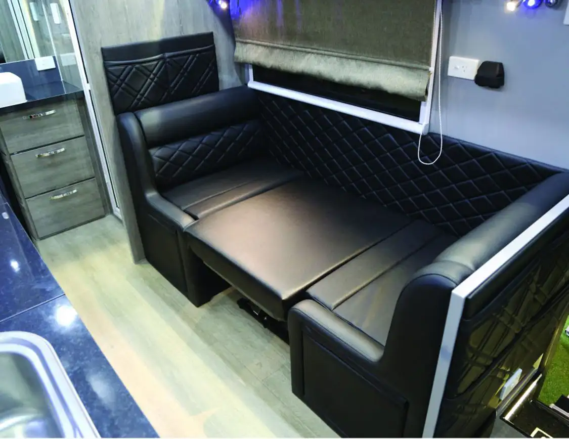 The kitchen table folds down to a bed