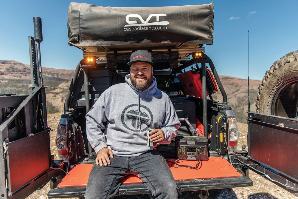 Ken Hoglund sits on the tailgate of his truck