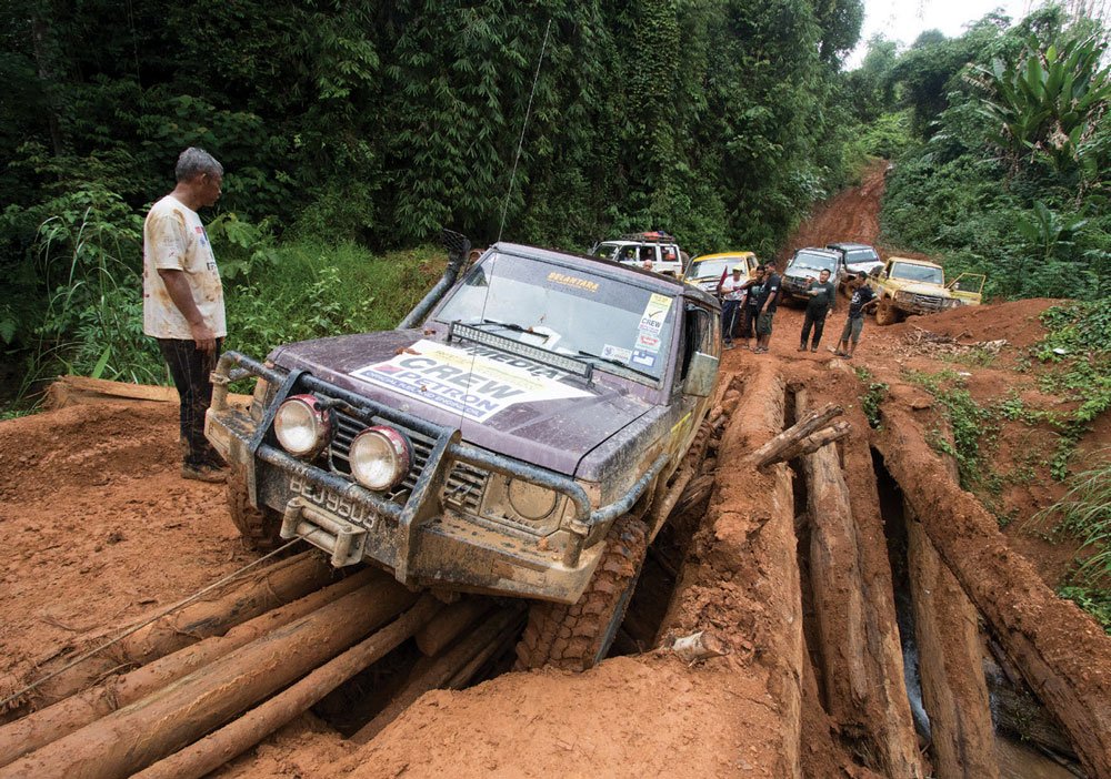 Crossing a dilapidated bridge in the Malaysian Highlands