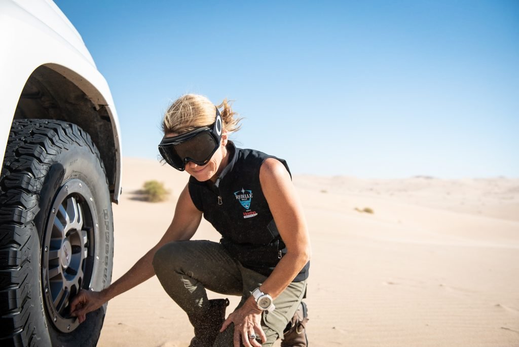 Emily Miller checking the tires