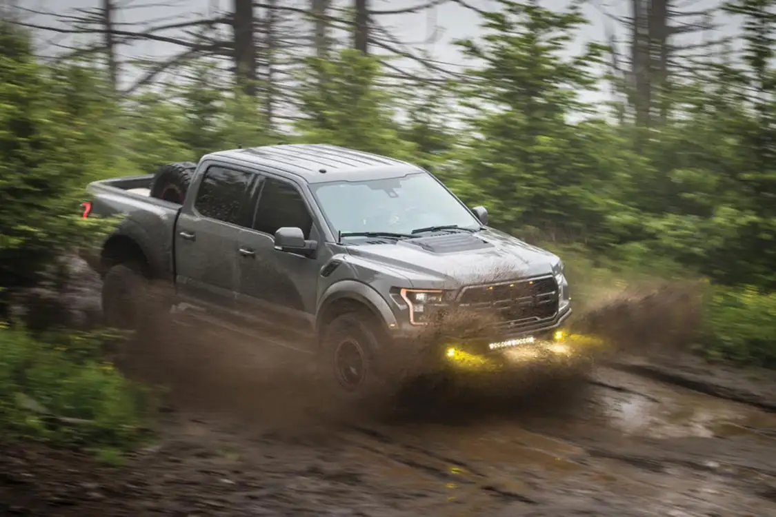 2018 Ford Raptor Supercrew driving in the mud