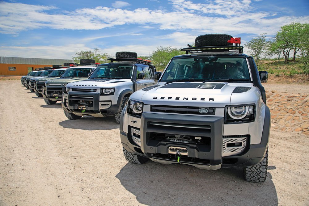 Land Rover Defenders lined up waiting for drivers