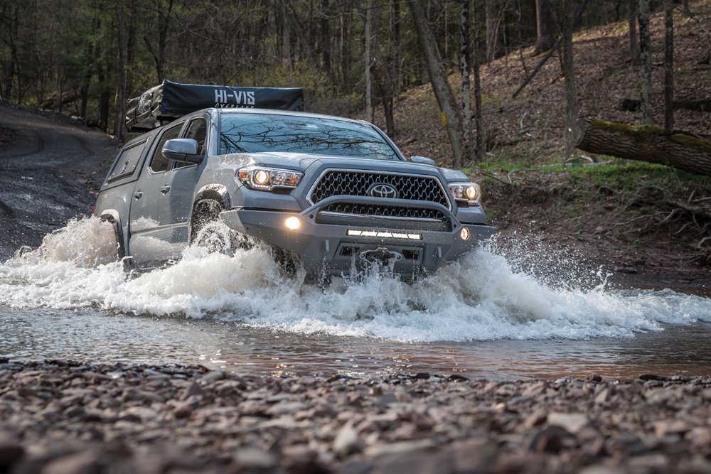 Toyota Tacoma driving through shallow water