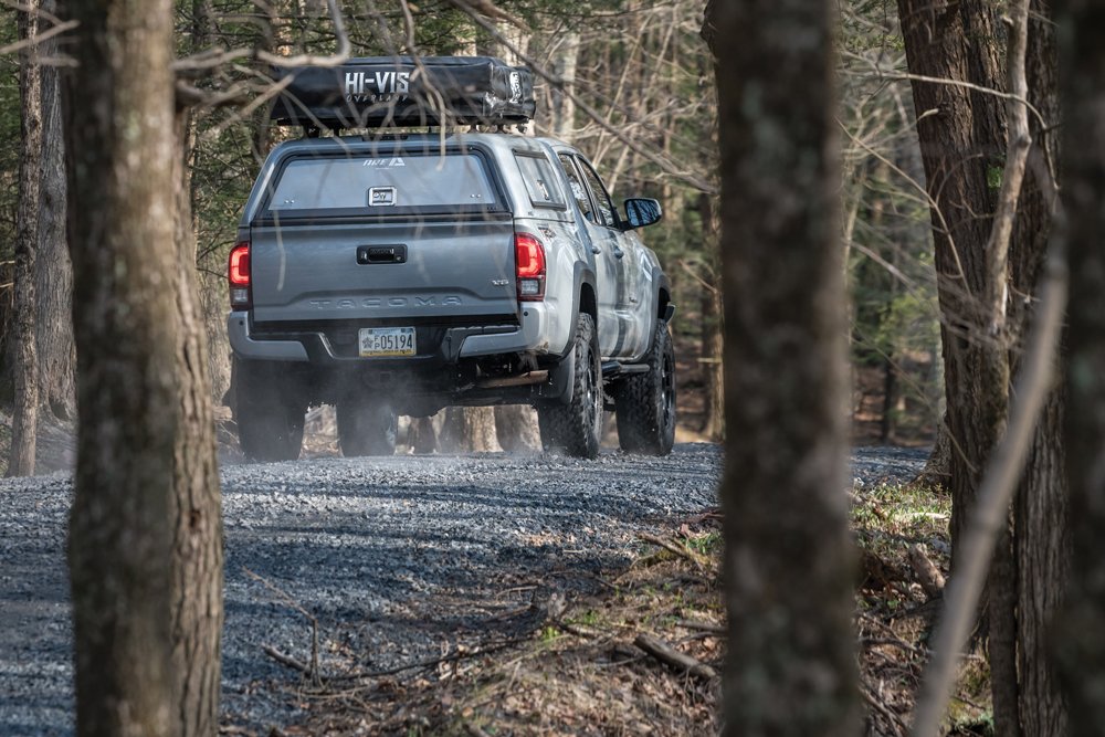 Rearview of the Tacoma driving down a gravel road