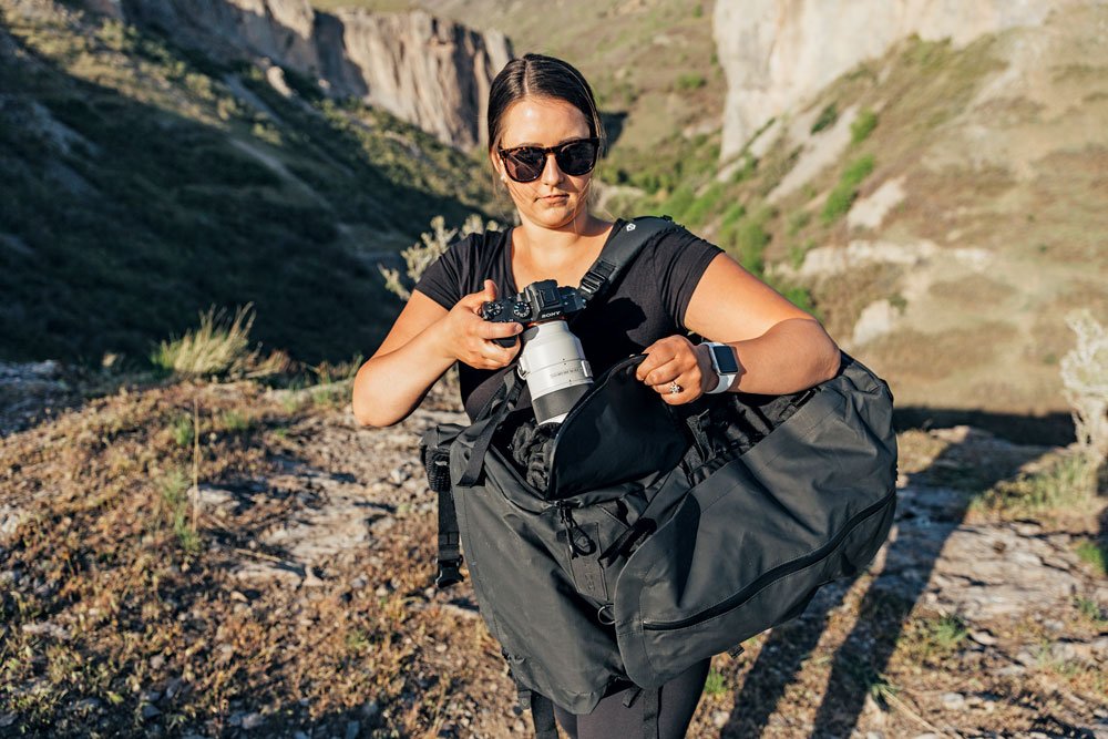 A woman utilizes the perfect camera bag