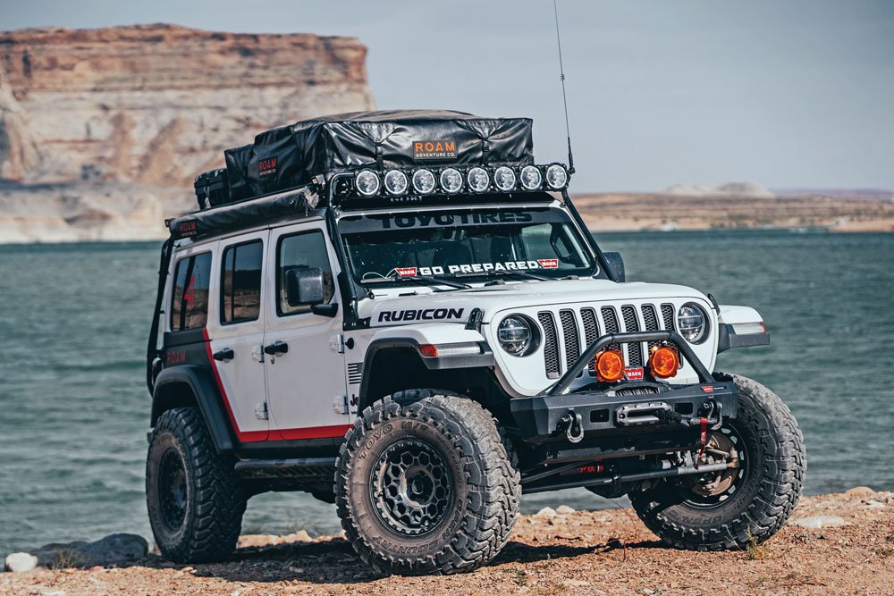 The Roam Rubicon posed in front of a lake