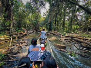 Taking a photo using a camera phone on a canoe in the jungle