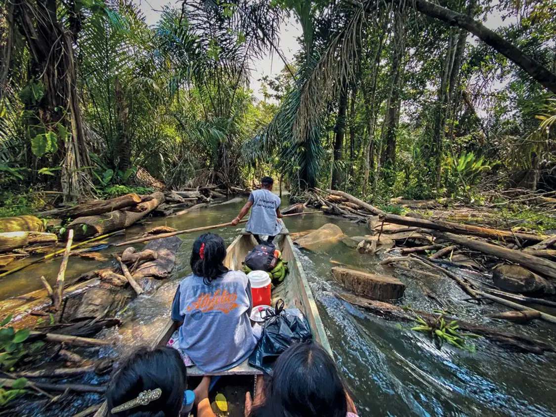 Taking a photo using a camera phone on a canoe in the jungle 