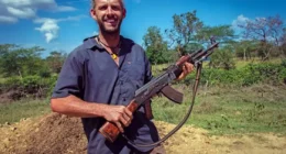 World traveler Dan Grec poses with AK-47 in Ethiopia.