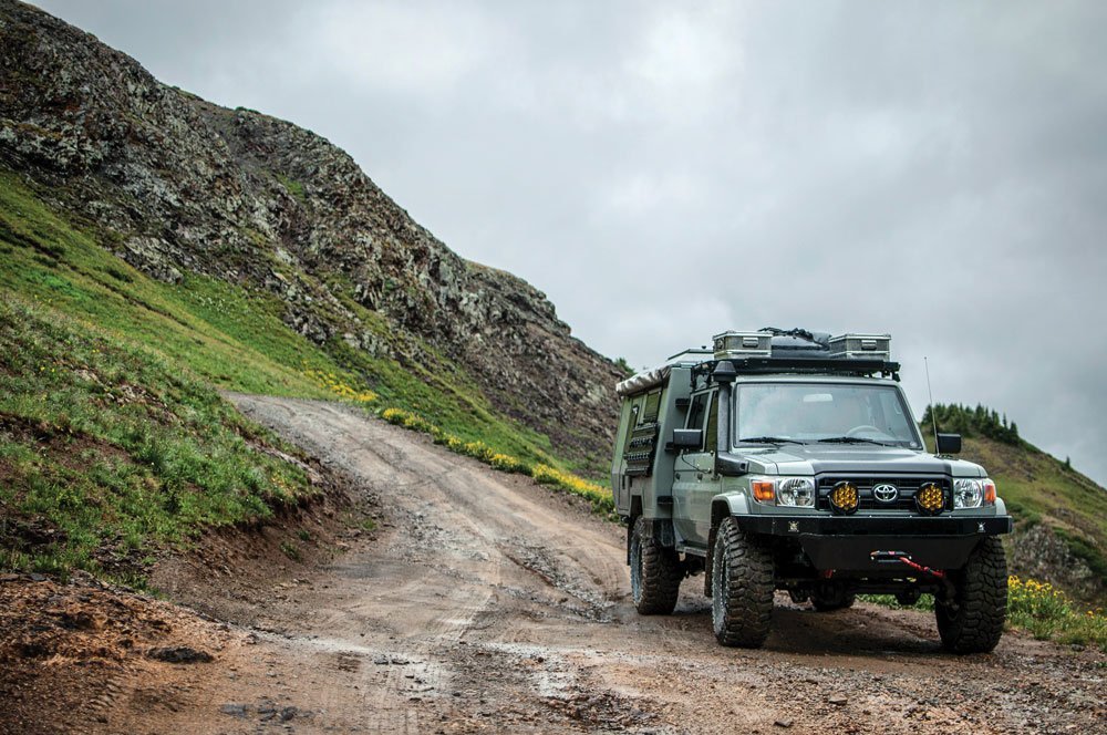 Maltec ’93 Land Cruiser 80/79 series parked on side of mountainside trail