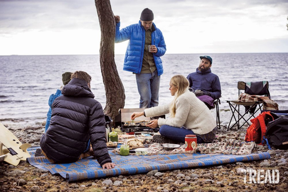 Campers cooking with the Primus Tupike portable stove at beach.