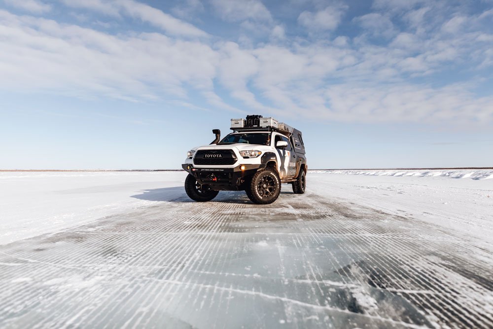 Truck stops on icy road in Arctic Canada.