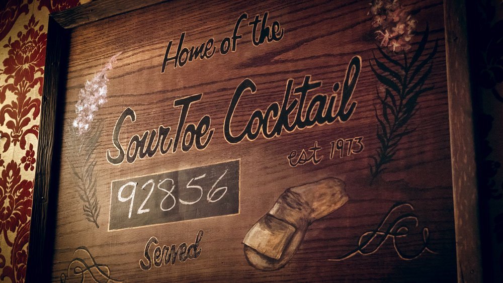 Sign that says, "Home of the Sour Toe Cocktail."