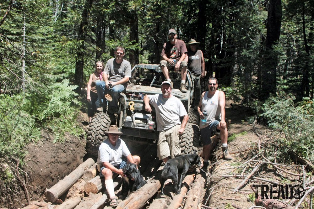 Friends of the Rubicon and the Rubicon Trail Foundation standing in front of customized 4x4 sitting on logs supporting land-use activism.