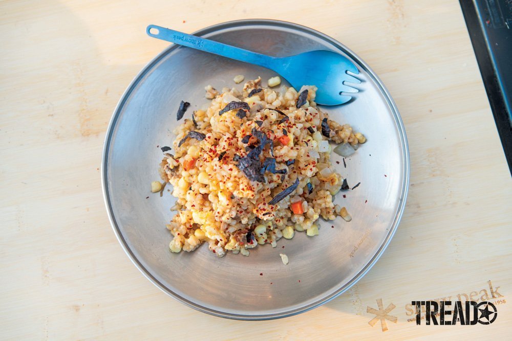 Camp Yoshi Frazier’s take on fried rice, with nori (seaweed) crumbles on top and spork sitting on plate..