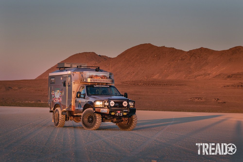 A overlanding 4x4 camper posed during golden hour