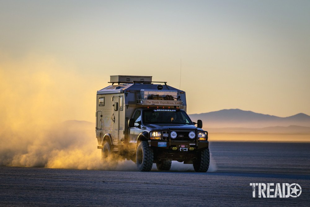 Expedition camper driving on dried lakebed