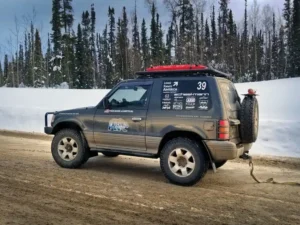 Pajero pulling Xterro out of a ditch using recovery gear