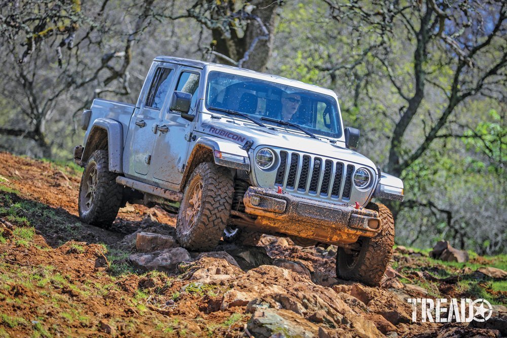 EcoDiesel will be offered as the Gladiator Sport, Overland, and Rubicon models (a silver Gladiator is shown driving offroad)