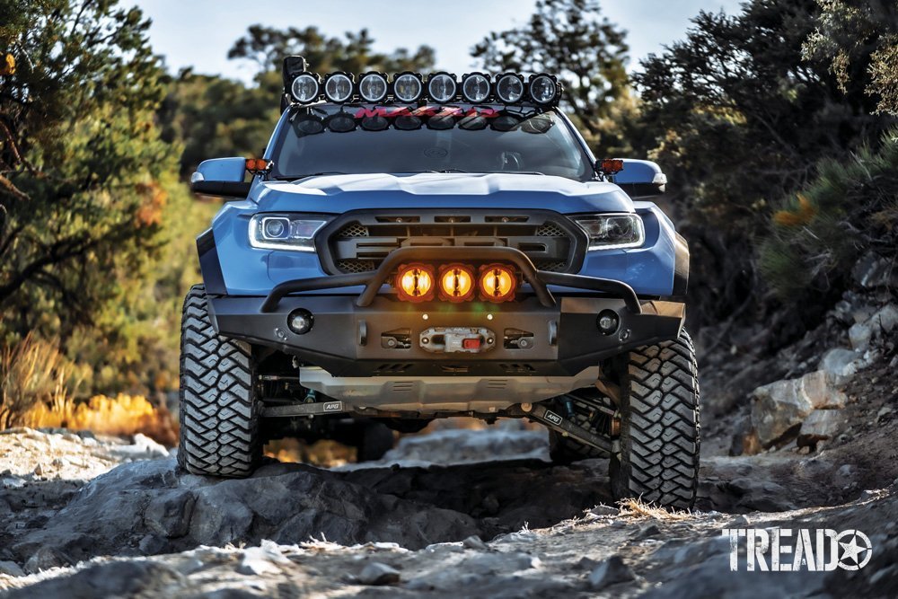 Head on shot of this customized 2019 Ford Ranger shows aftermarket bumper, lights, winch, and knobby tires