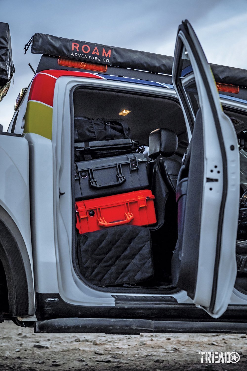 Gray and red Pelican cases in the 2019 Ford Ranger with the door opened.