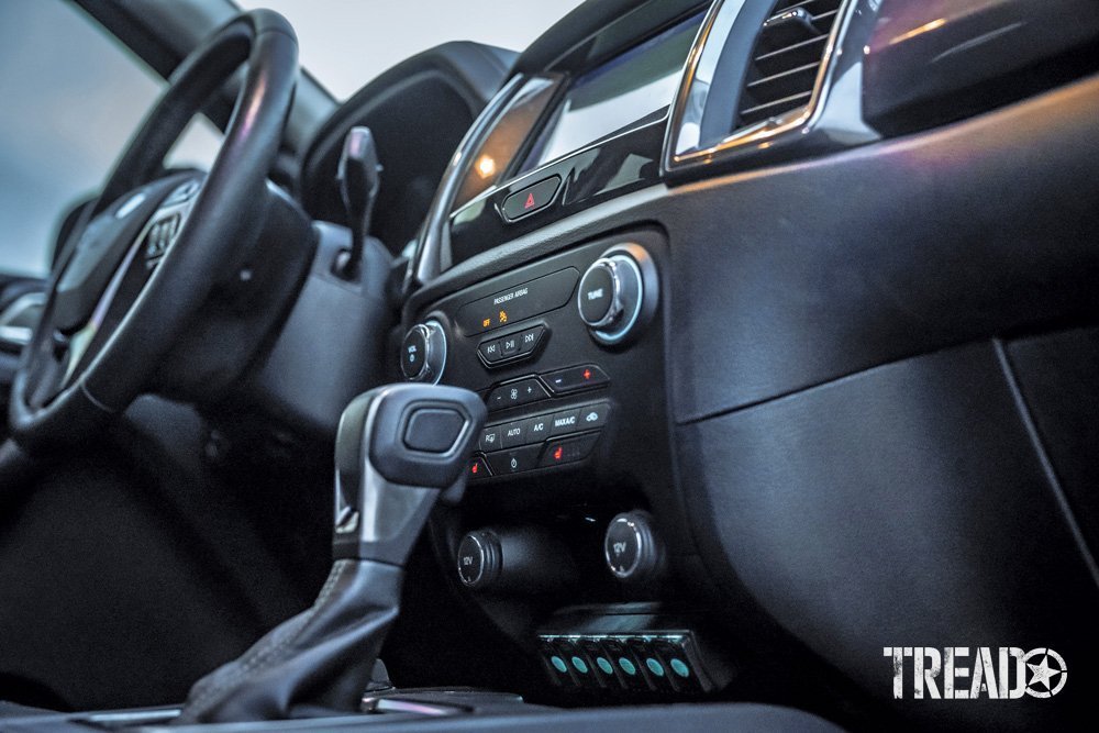 The interior of the 2019 Ford Ranger shows a black and dark gray assortment of materials and buttons.