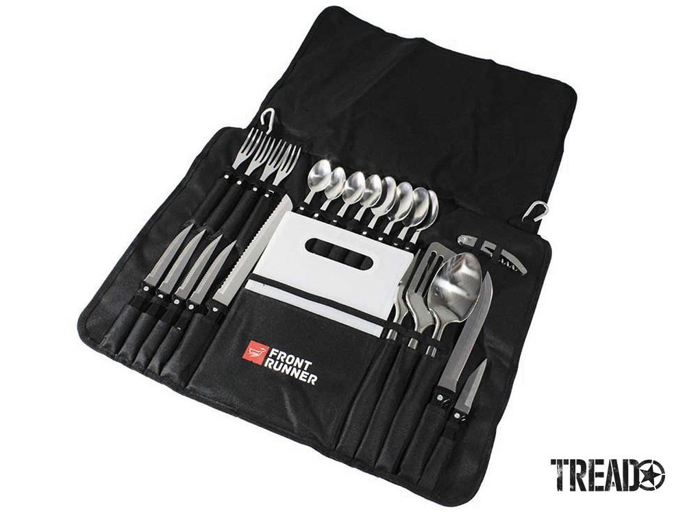 The black Front Runner Outfitters' Camp Kitchen Utensil Set neatly showcases a set of four silverware and serving utensils, and cutting board.