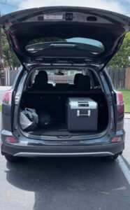 Rear cargo area of 2017 Toyota RAV4 with Dometic fridge.