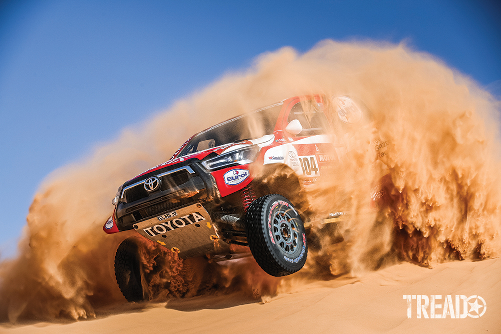 2021 Dakar ralliers in red and white Toyota, 304 De Villiers Giniel (zaf), Haro Bravo Alex (esp), crash through a huge sand dune in plume of dust. 