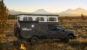 Black truck and Terranova camper with pop top open