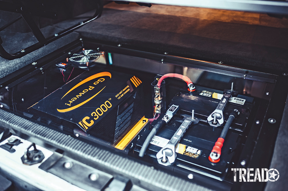 2006 E350 Super Duty 4x4 inverter and battery is neatly packed into an in-floor cubby in the van's interior.