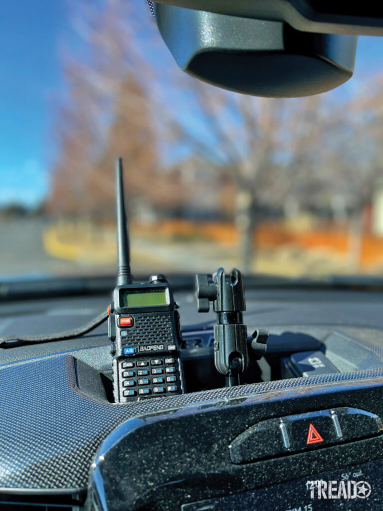 Most vehicles offer spots, such as cup holders or storage, for handheld radios, like in this centrally located dash cubby. 