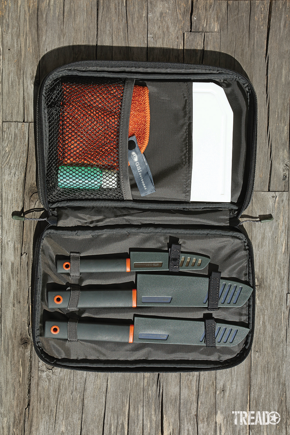 Each dark gray knife and items stow neatly in the GSI Santoku Knife Set zippered carry bag.