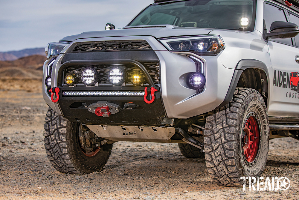 Rigid Industries lights up front, AJC embellishments, red bow shackles, and steel skid plate add unique styling details to the look of this 4Runner.